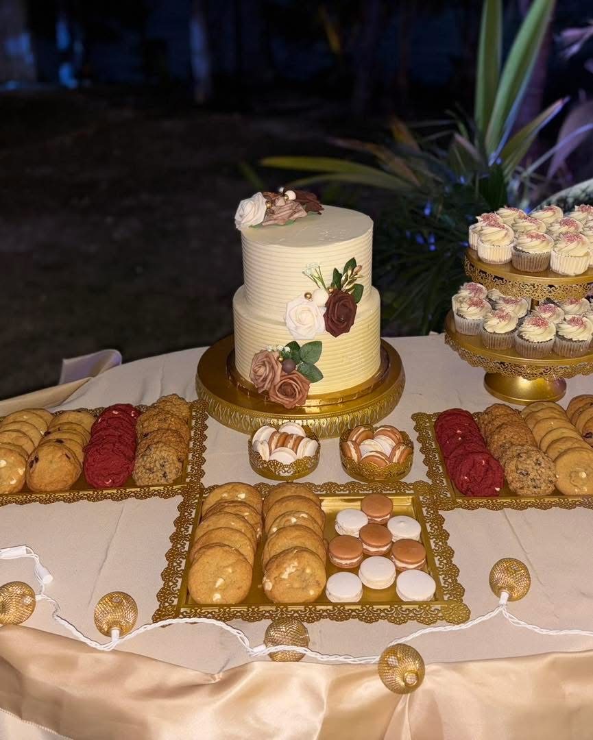 Dessert table with cake, cupcakes, cookies and macarons